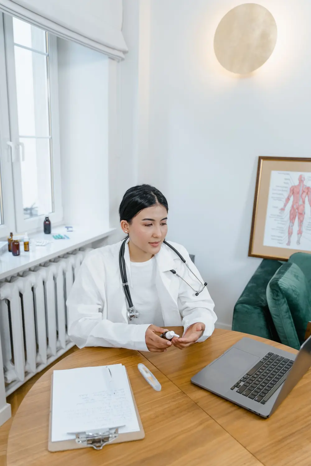 A doctor holding a video consultation from a laptop